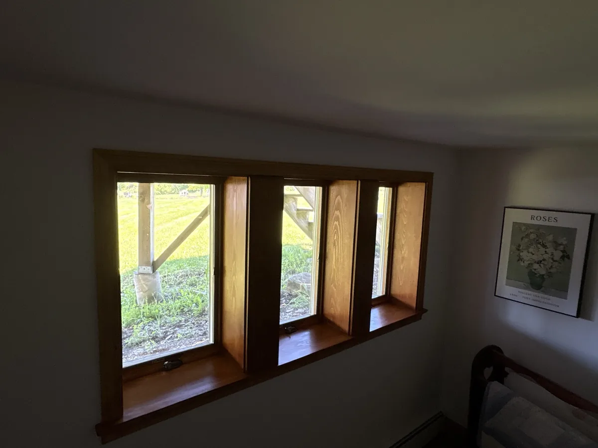 Replacement windows with finished wood trim.
